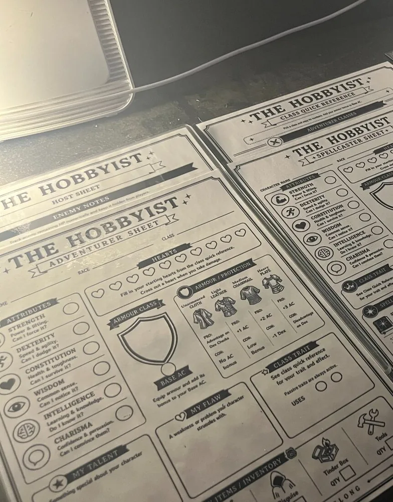 The Hobbyist character, spellcaster, Host and quick-reference sheets laid out together