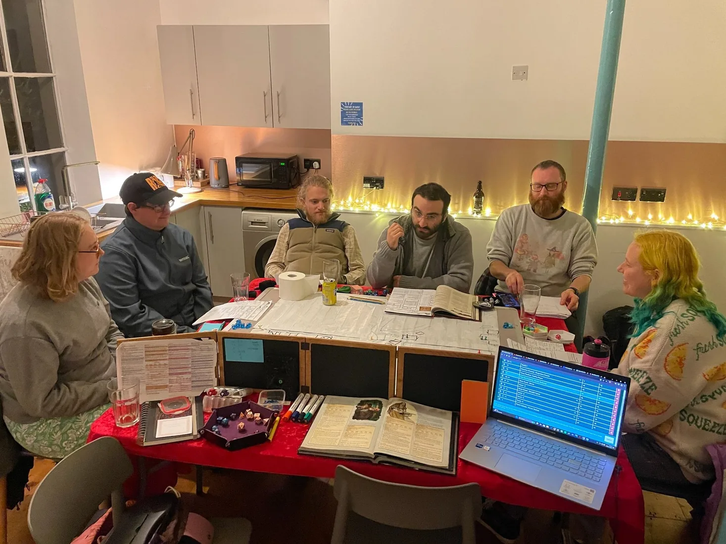 A tabletop group talking and laughing together during a game session